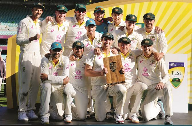 The Australian team, which captured the Test series by two nil, can be seen happy with the trophy; (PTI)